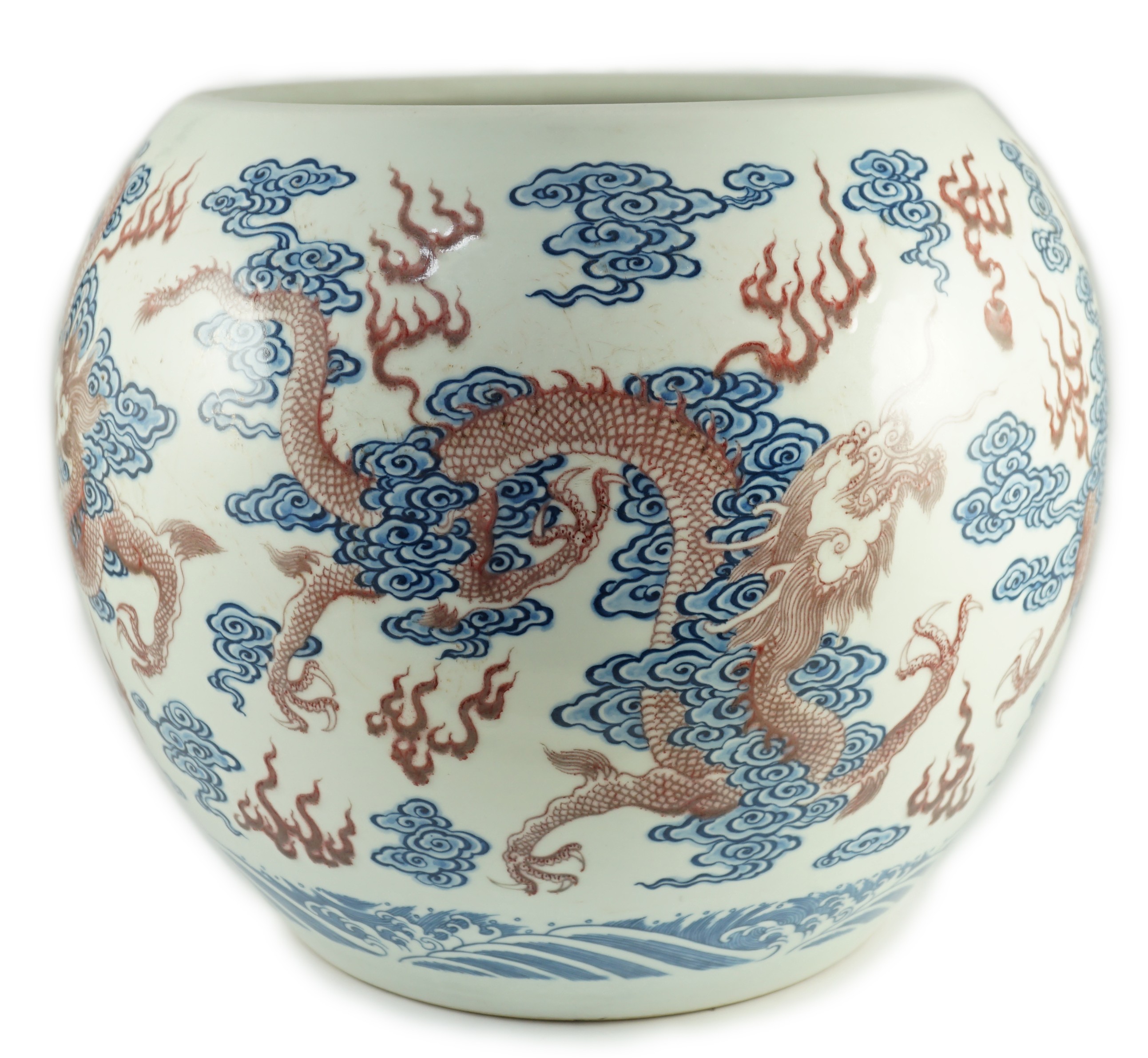 A large Chinese underglaze blue and copper red 'dragon' scroll vessel, 42.5cm diameter, 34.5cm high